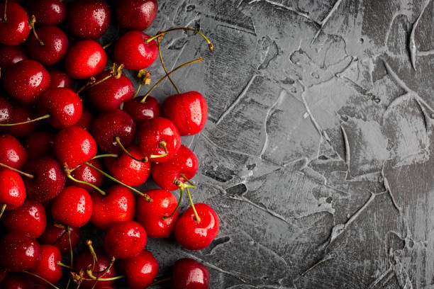 istock Fresh Cherry with water drops on black stone background. Flat lay Concept 1326679624