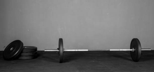istock Olympic bar with weight plates in gym 1326680510