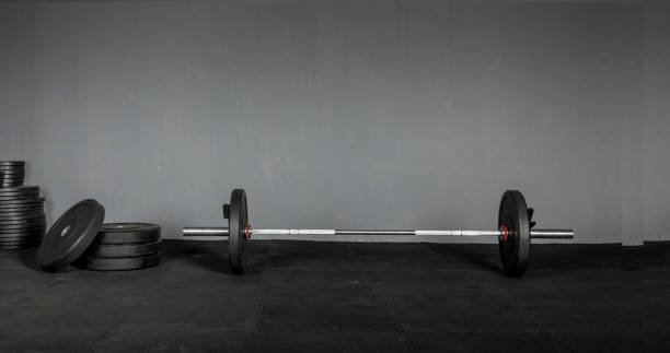 istock Olympic bar with weight plates in gym 1326681879