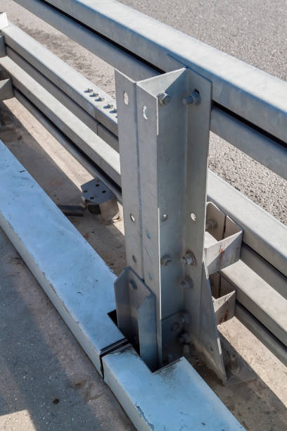 istock metal roadside fence support with connecting elements and bolts with nuts. Galvanized or metal road barriers. Road safety, protective structures. 1326685248