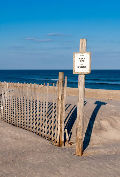 istock A Keep Off sign and fence on fragile sand dunes 1326685545