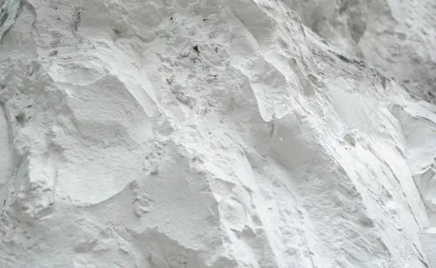 Chalk mining. Limestone quarry. Opencast mining. Chalk hills. Chalk surface. White Stone Texture background wallpaper.