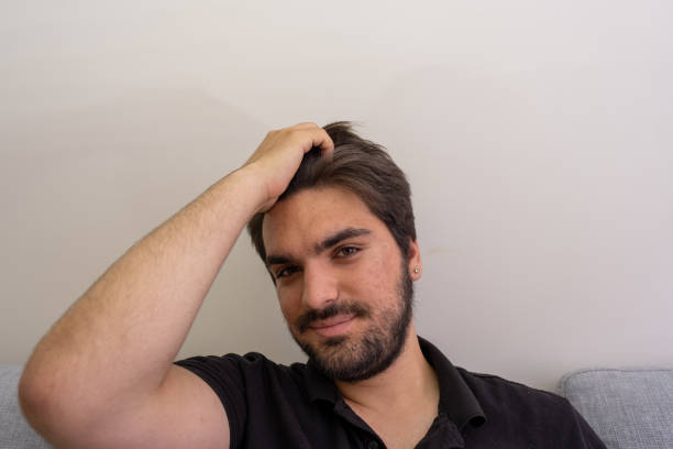 istock a handsome young pimpled man with red acne combing his hair back 1326691750