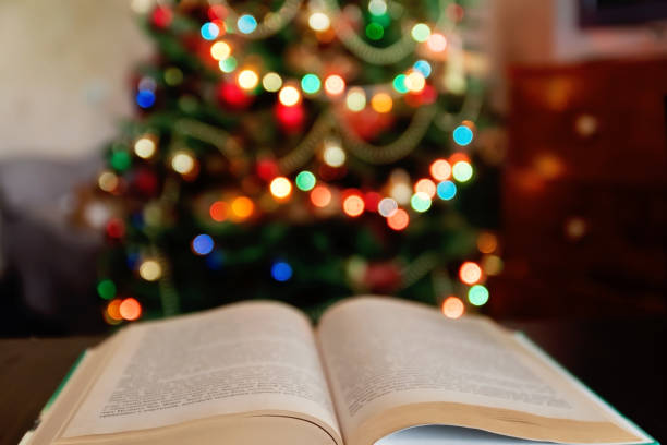 Christmas and bible with blurred candles light background