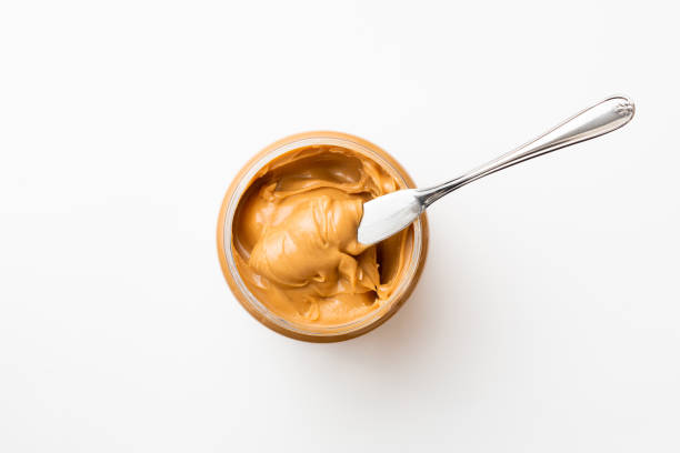 Peanut butter bottle open jar of peanut butter with spoon peanut butter stock pictures, royalty-free photos & images