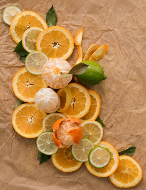 Creative designed background. Citrus fruits on brown background.