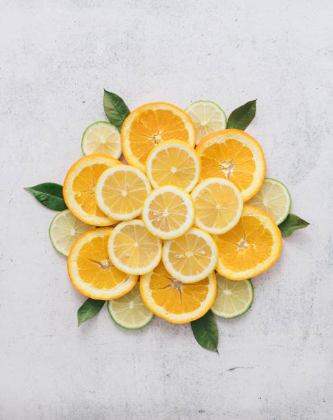 Orange, lemon and lime slices arranged in mandala shape. Minimal still life. Concepts.