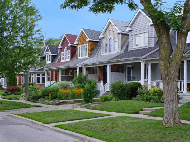 Residential street with small semi-detached houses Residential street with small semi-detached houses with gable dormer windows small stock pictures, royalty-free photos & images