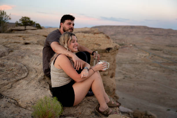 Young Couple Enjoying A Romantic Sunrise During A Camping Getaway Weekend