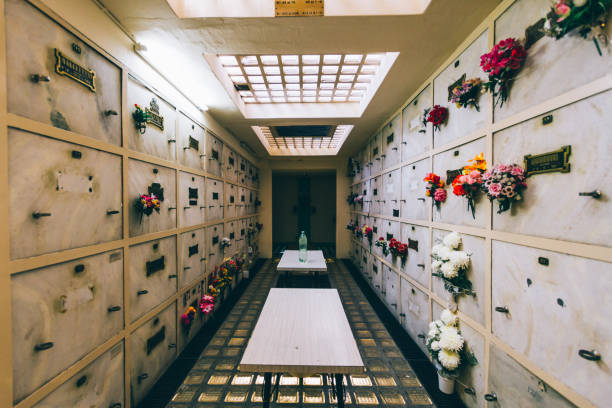 Cemetery niches with flowers in a corridor Cemetery niches with flowers in a corridor crypt stock pictures, royalty-free photos & images