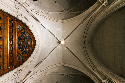 Vaulted ceiling of a church with wooden door