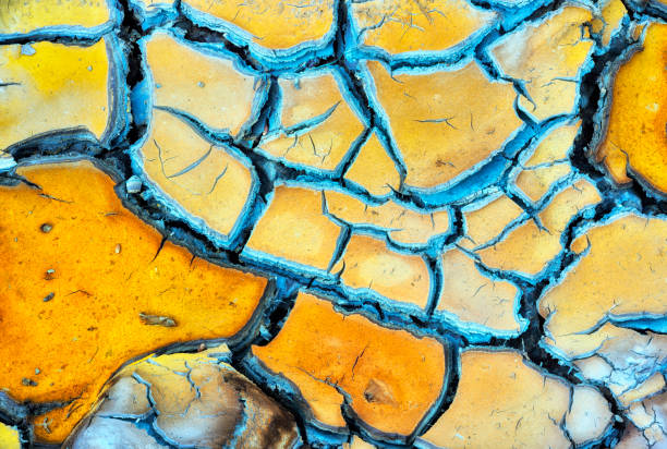 istock dry and cracked mud landscapes 1326706941