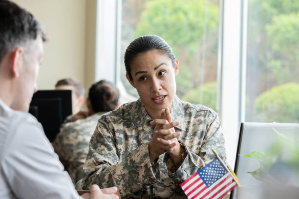 istock Female military recruiter explaining options to servicemen. 1326707776
