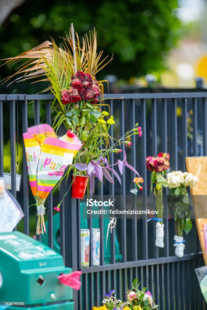 Flowers at Surfside Miami in honor of the people lost in the Champlain Towers Collapse USA Surfside - Florida Stock Photo