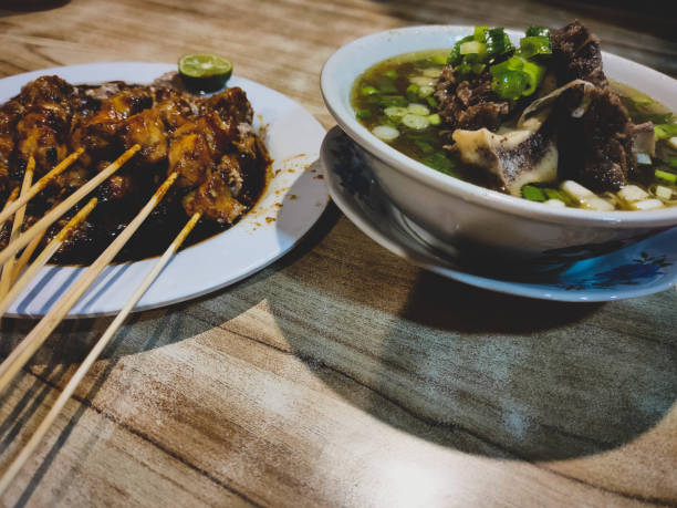 istock Meat soup and satay on wooden table 1326718844