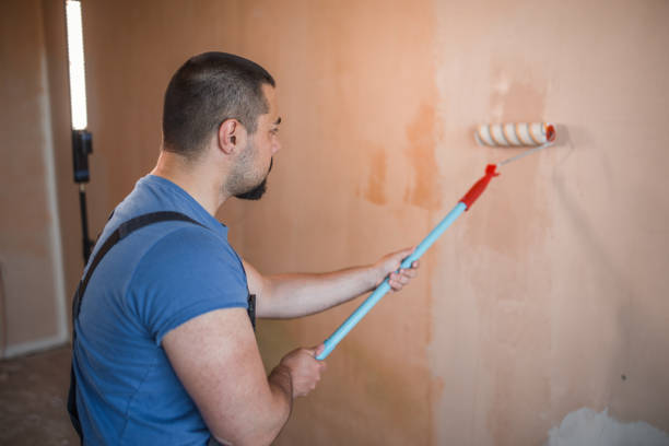 istock Painter in coveralls in the action 1326729308