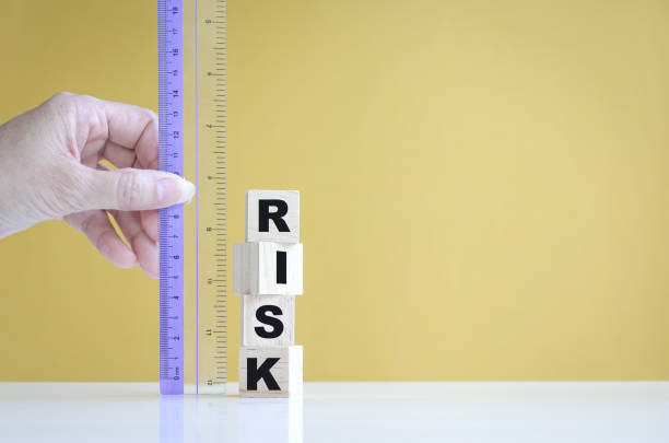 istock Businesswoman's hand  measure risk with a ruler. 1326732357