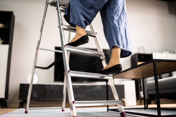 istock Ladder Safety. Woman Climbing Step Ladder 1326732715