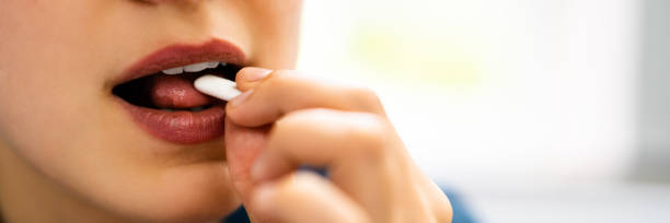 istock Woman Using Nicotine Gum To Quit Smoking 1326732743