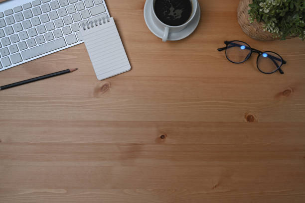 istock Top view office desk with notebook, coffee cup and eyeglasses. 1326733632