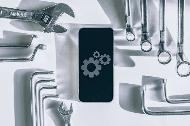 istock Mobile repair service. Technician workplace with phone and special repairing tools. Electronics repair service, device production concept. 1326733755