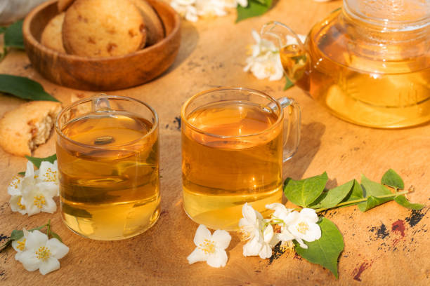 istock Green Chinese tea with jasmine in a mug with jasmine flowers. 1326736310