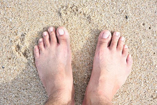 Close up of woman's legs standing in the sea