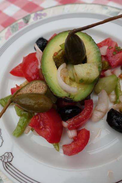 istock Avocado served with seasoned raw vegetables and caprons  Vegetarian appetizer 1326740490