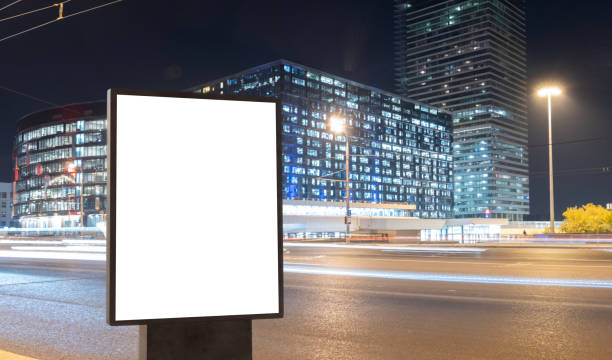 istock Blank billboard on a busy highway with traffic, neon lights 1326740824