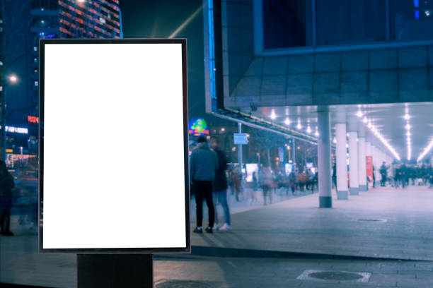 istock Blank billboard on a busy highway with traffic, neon lights 1326740849