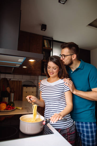 istock Young couple cooking together at home 1326743870