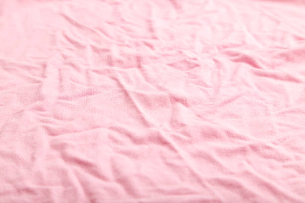 istock Fragment of pink cotton tissue. Side view, natural textile background and texture. 1326747374