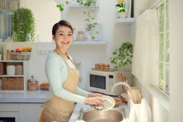 istock young woman washed the dishes in a kitchen 1326747779