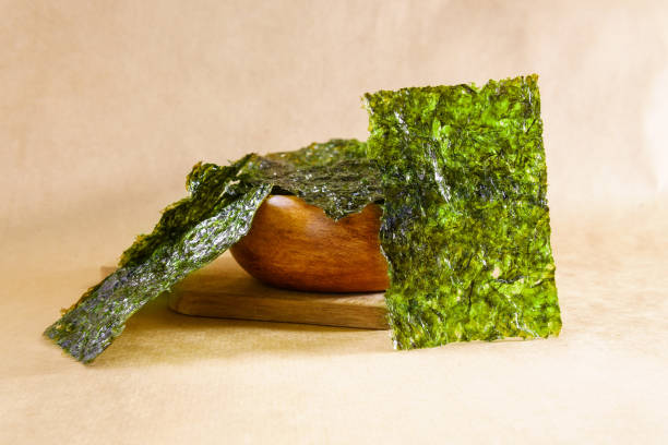 Crispy nori seaweed close up. Japanese food nori. Dry seaweed sheets. Japanese food nori dry seaweed or edible seaweed close-up. nori edible seaweed sheet stock pictures, royalty-free photos & images