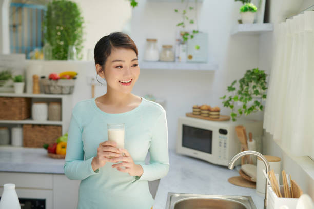 istock Smiling attractive woman having breakfast in kitchen interior 1326748632