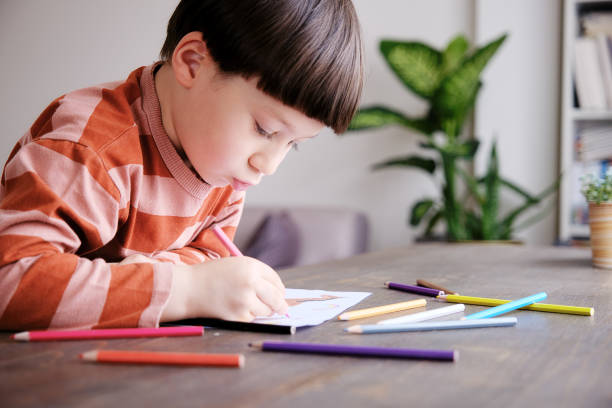 istock Cute child drawing at home 1326755327