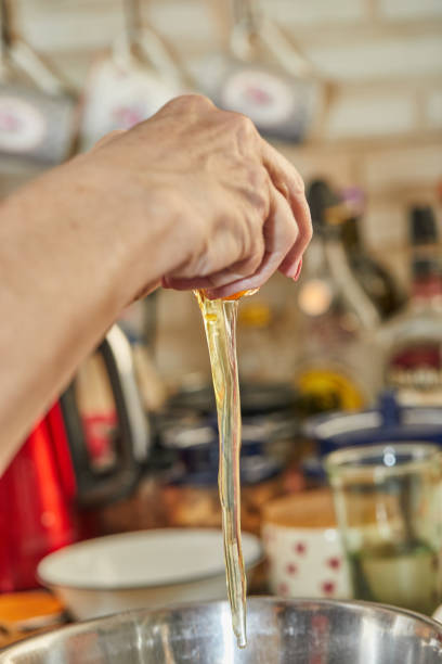 istock Chef drives an egg into bowl for cherry pie, clafoutis. Step by step recipe 1326757086