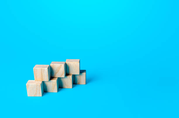 istock Simple cubic shape assembled from blocks on a blue background. Minimalism. Simple shapes geometry. Slide for presentation. Copy space, place for text. 1326757474