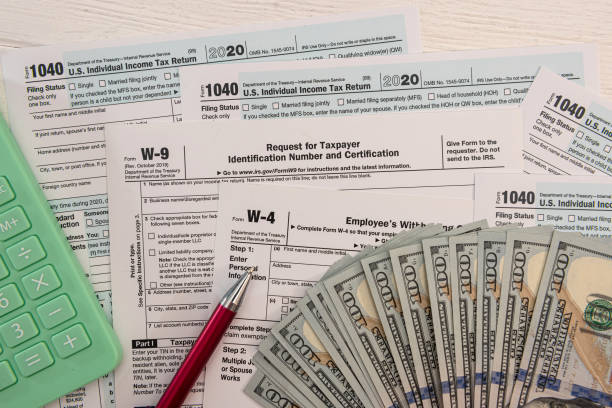 istock US individual 1040 form with dollar bills calculator and pen paperwork 1326757832