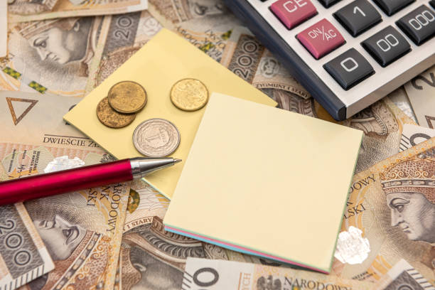istock Polish zloty bills with calculator pen and note 1326758977