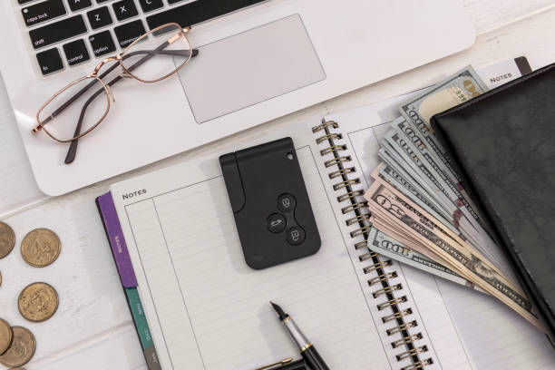 istock Car keys with dollar bills on laptop keyboard 1326761542