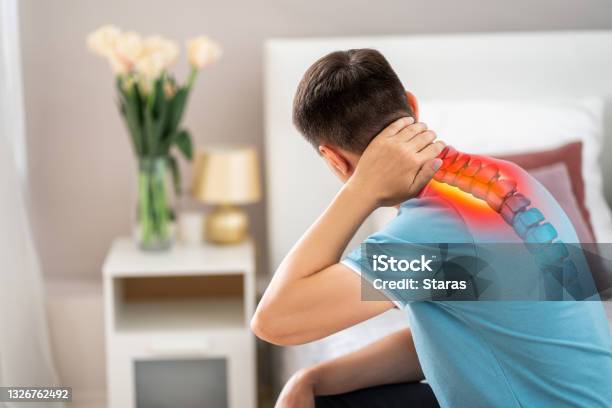 Hernia Of The Cervical Spine Neck Pain Man Suffering From Ache In The Bedroom Compression Injury Of The Intervertebral Disc Stock Photo - Download Image Now
