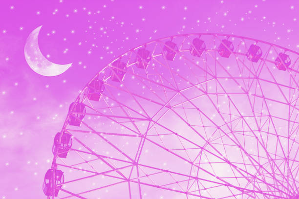 Vintage photo with ferris wheel against the moon colorful sky