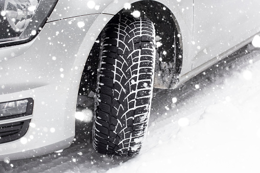 Close-up of car tires in winter on a snowy road