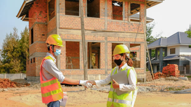 istock Engineer contractor team hand shake after meeting work safety plan industry project and check design at the construction building site 1326766884