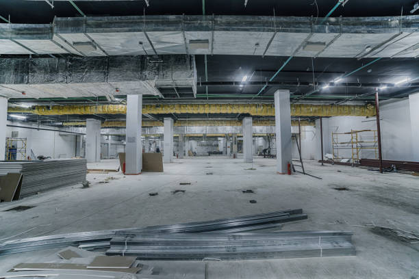 Construction of spacious well-lit underground car park with parking spaces. Empty parking garage underground, industrial interior