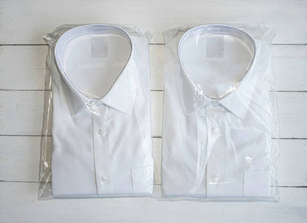 istock White shirt folding in the package on wooden background with copy space. 1326768089
