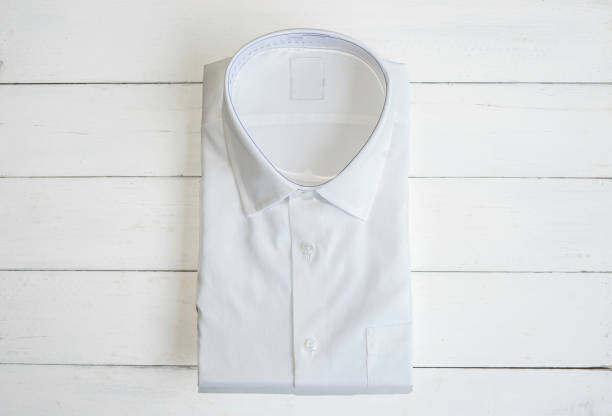 istock White shirt folding in the package on wooden background with copy space. 1326768104