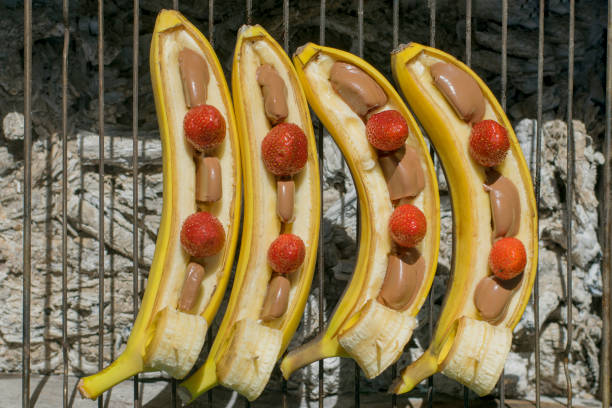 Bananas on the grill with chocolate and strawberries. Top view