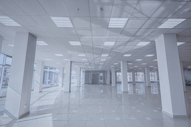 istock Spotlight and empty space. Empty office space in modern building. Interior of empty unfinished modern market. Architecture concept. Empty white room has white walls. Shopping center 1326769403